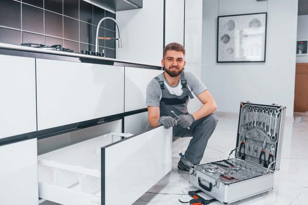 young-professional-plumber-in-grey-uniform-using-e-resize.jpg young-professional-plumber-in-grey-uniform-using-e-resize.jpg